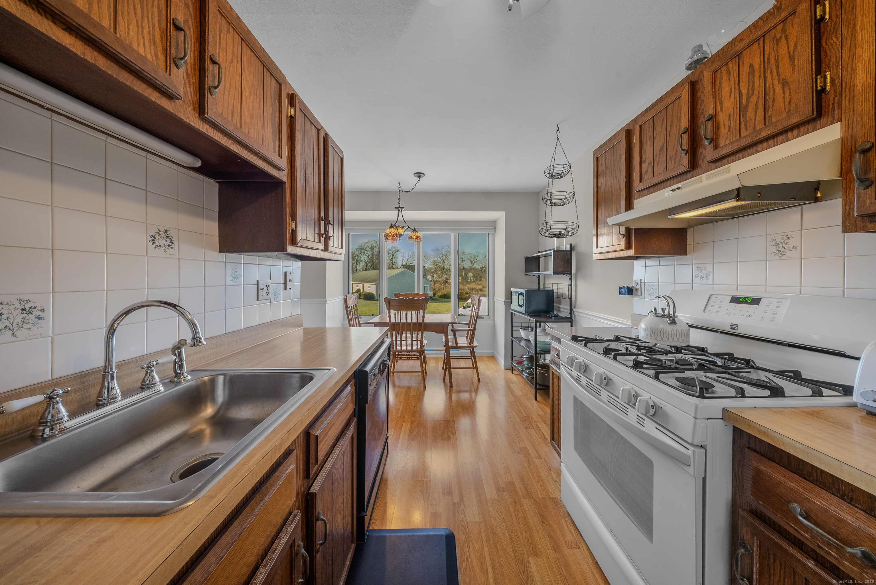 83 Carriage Drive, Unit 83 Milford, CT 06460 - Photo 7 of 33 a kitchen with stainless steel appliances granite countertop a sink stove and cabinets