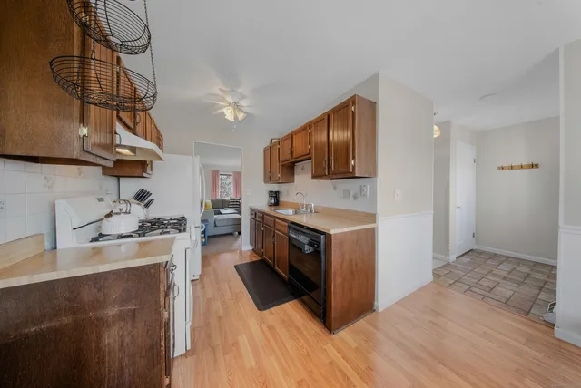 a kitchen with a stove a sink and a refrigerator