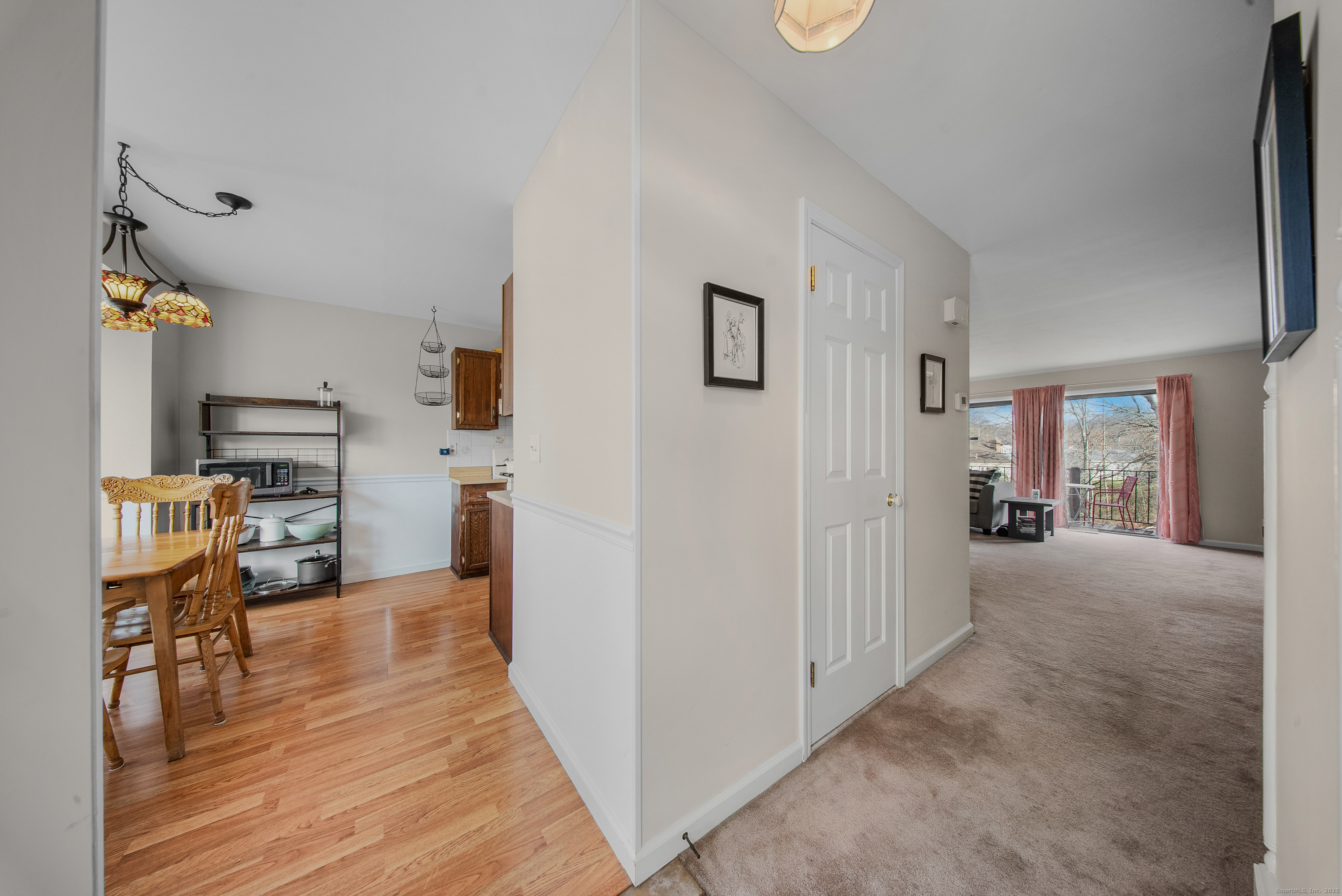 83 Carriage Drive, Unit 83 Milford, CT 06460 - Photo 10 of 33 a view of a kitchen with furniture and wooden floor