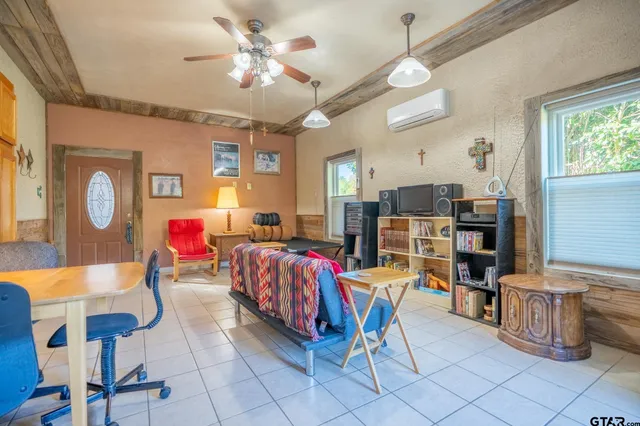 a living room with furniture a dining table and kitchen view
