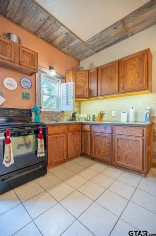 a kitchen with cabinets and window