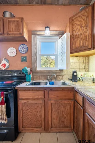 a spacious bedroom with a bed and wooden floor