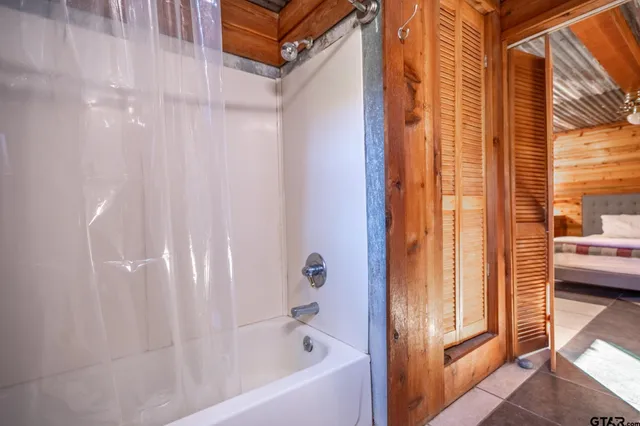a view of a room with wooden floor and iron stairs