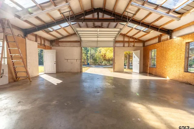 a view of a yard with wooden fence