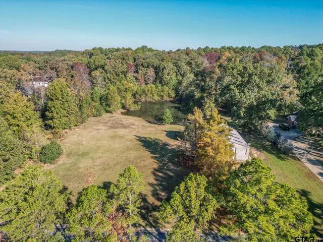 an aerial view of a houses with a yard