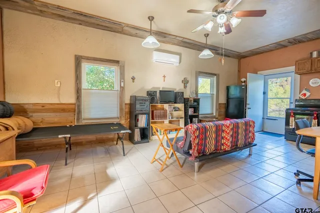 a living room with furniture a rug and a chandelier