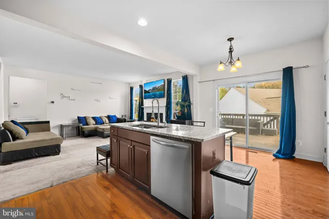 a kitchen that has a lot of cabinets in it and wooden floors