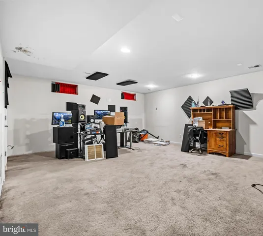 a view of a balcony with wooden floor and seating space
