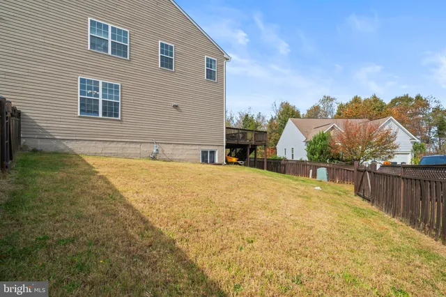 a view of a house with backyard sitting area and garden