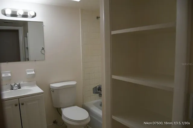 a white toilet sitting next to a bathroom sink