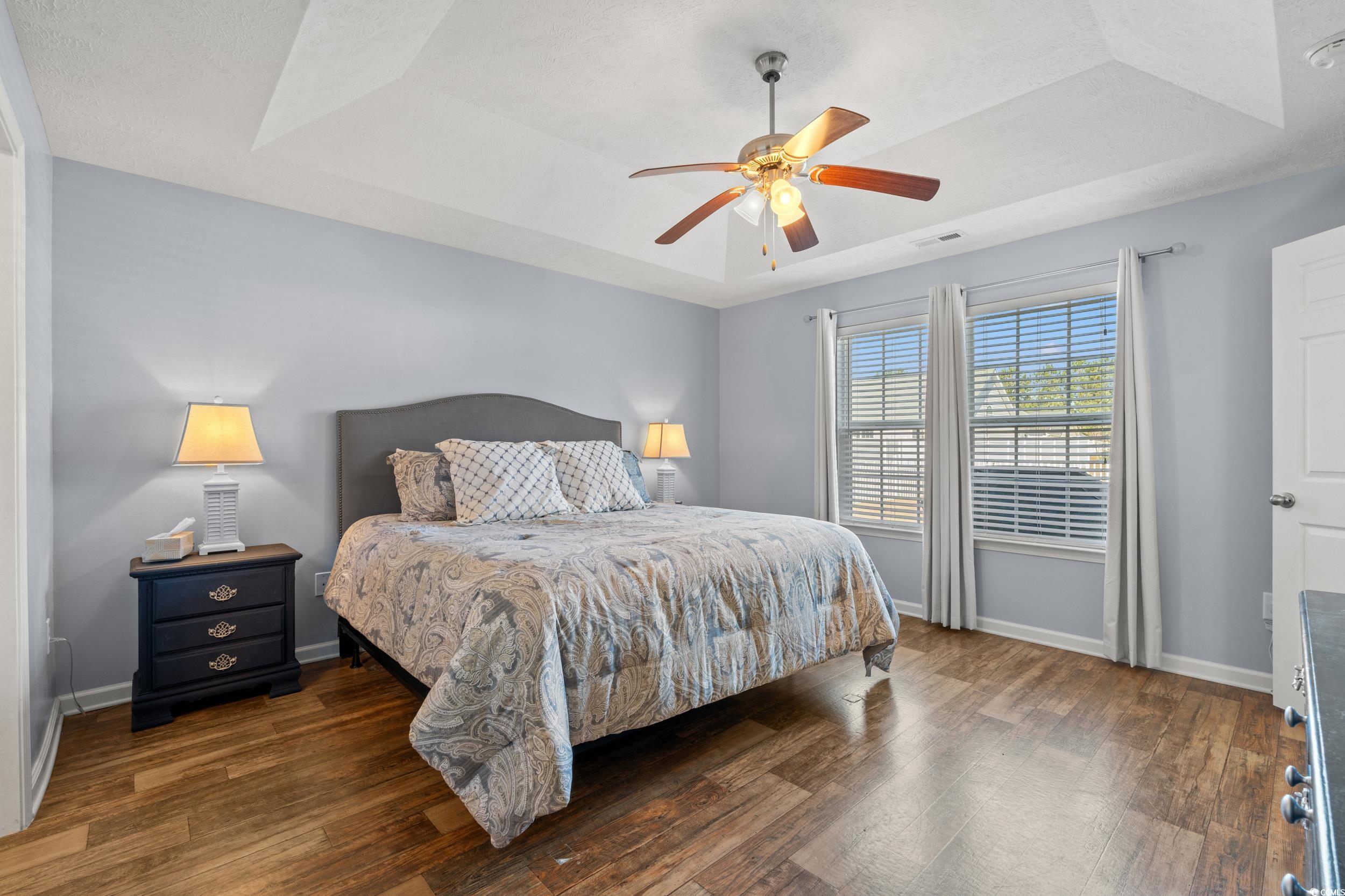 166 Woodland Park Loop Murrells Inlet, SC 29576 - Photo 11 of 39 Bedroom featuring ceiling fan, a raised ceiling, a