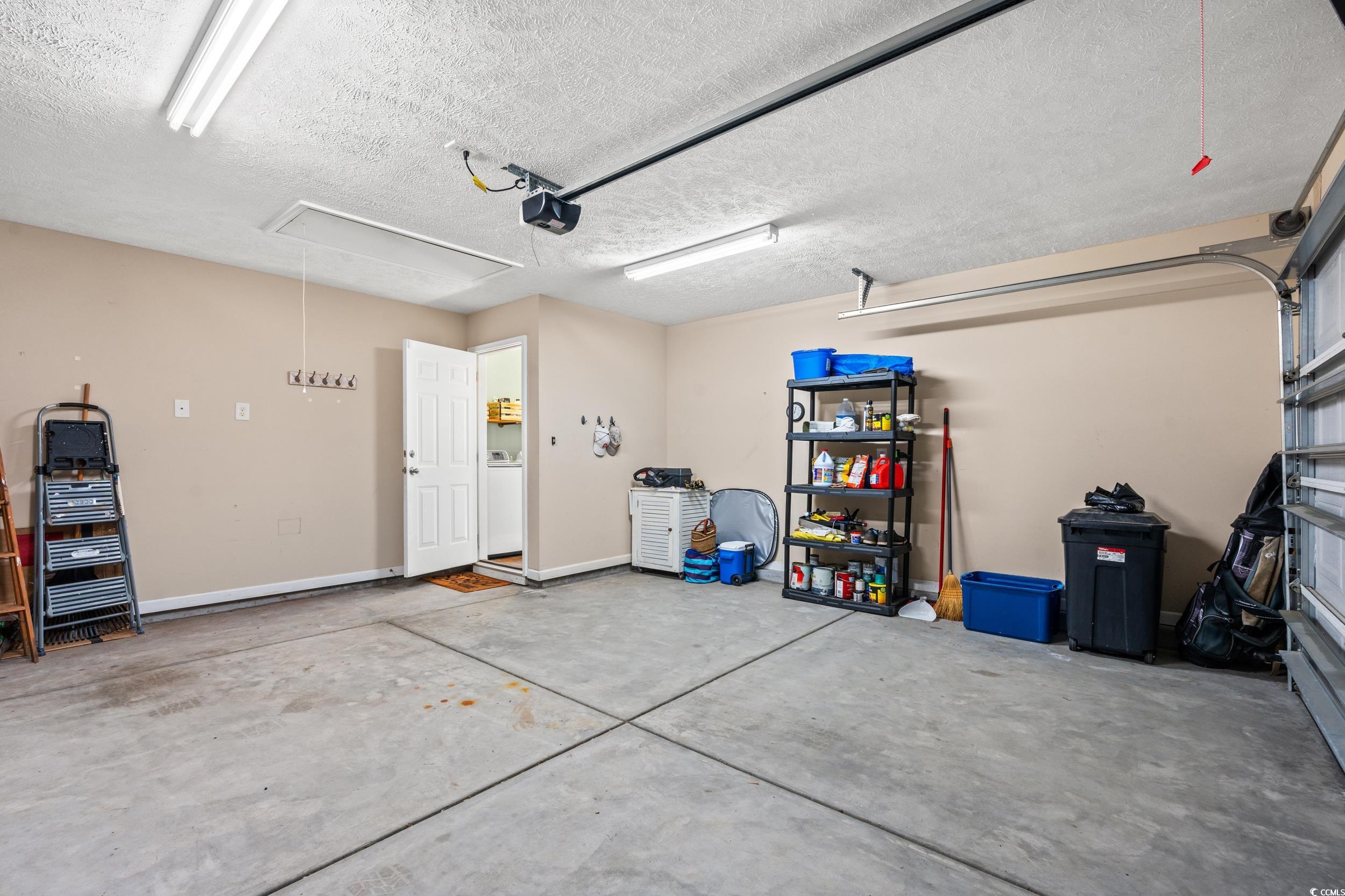 166 Woodland Park Loop Murrells Inlet, SC 29576 - Photo 26 of 39 Garage with a garage door opener