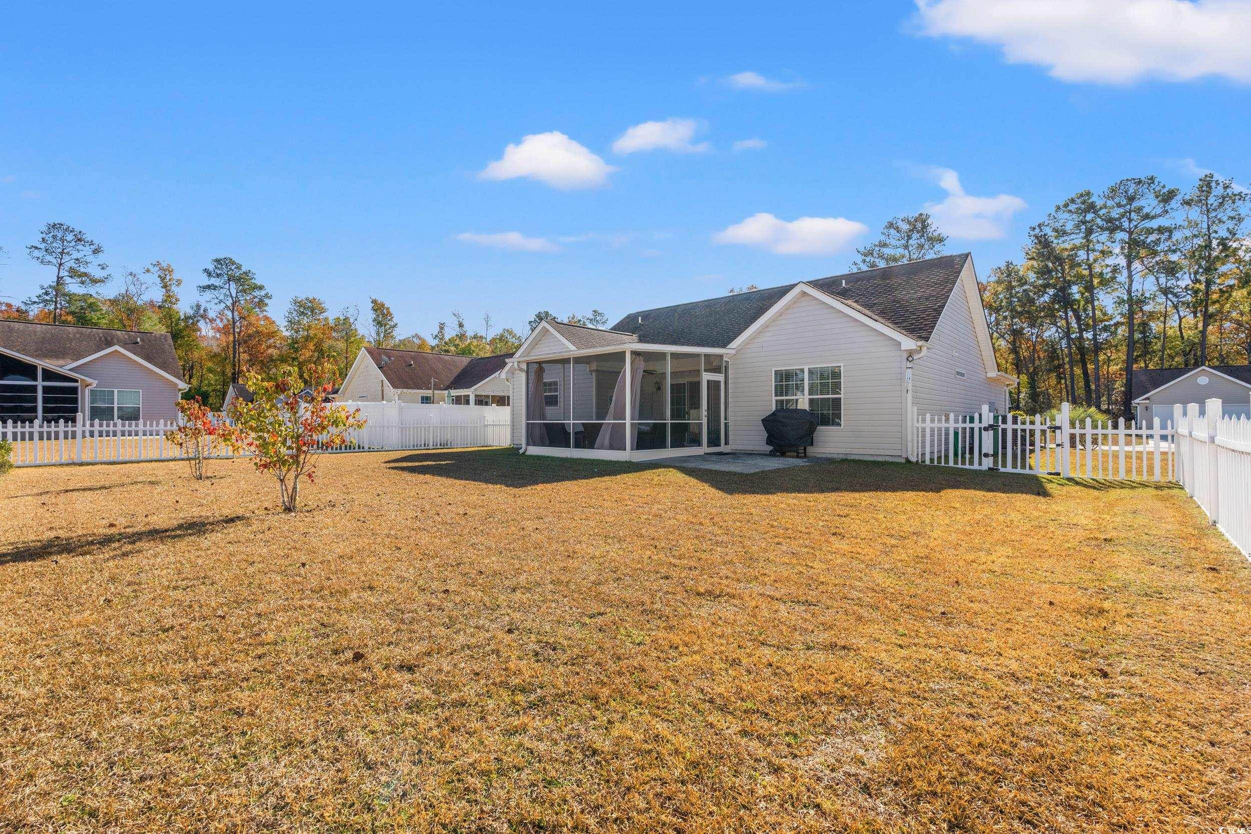166 Woodland Park Loop Murrells Inlet, SC 29576 - Photo 27 of 39 Rear view of house featuring a sunroom and a yard