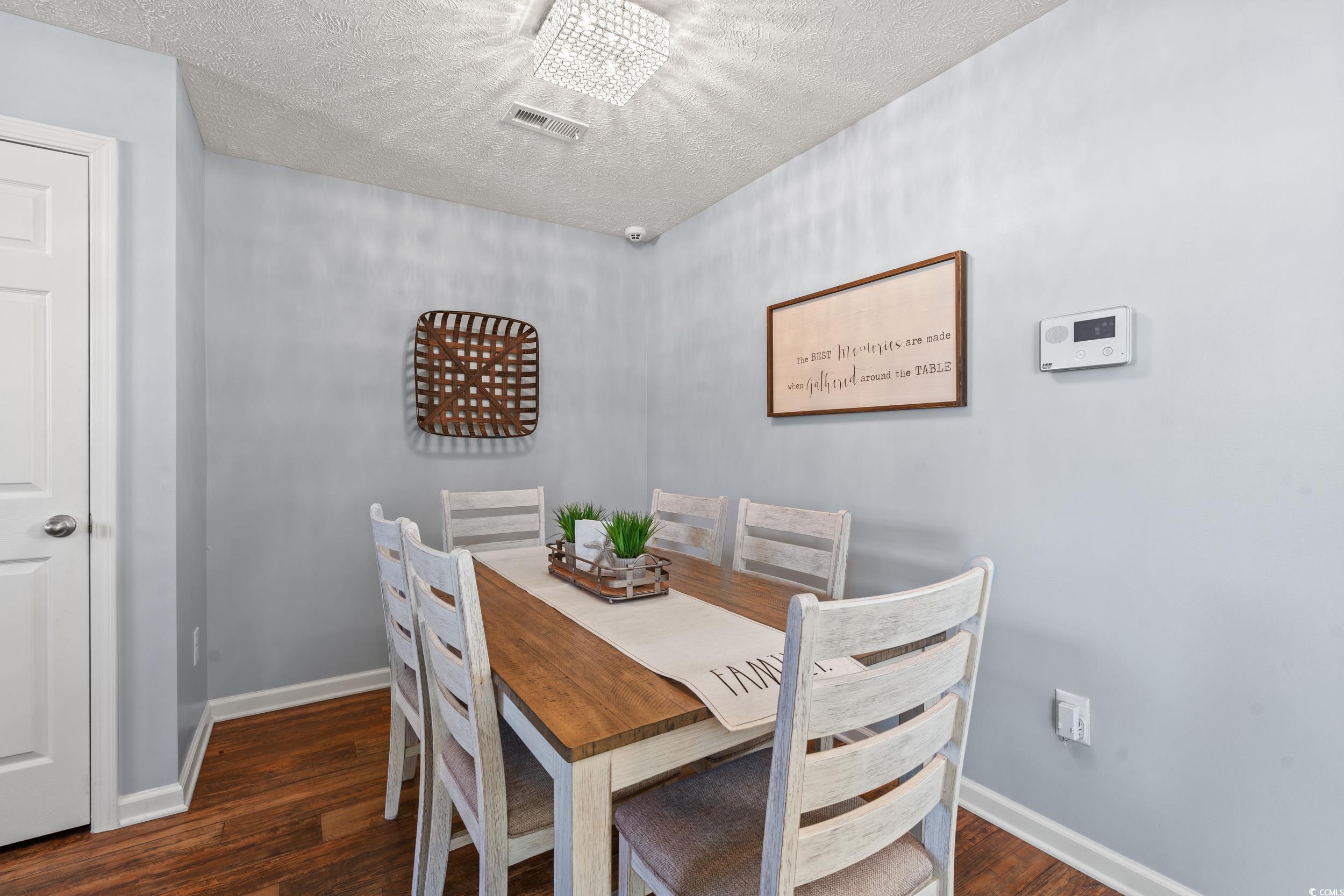 166 Woodland Park Loop Murrells Inlet, SC 29576 - Photo 9 of 39 Dining area with a textured ceiling, an inviting c