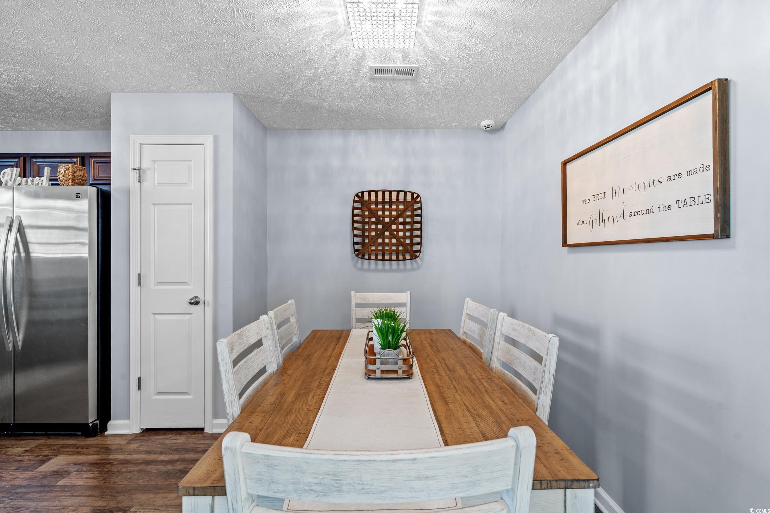 166 Woodland Park Loop Murrells Inlet, SC 29576 - Photo 10 of 39 Dining room featuring dark wood-type flooring and