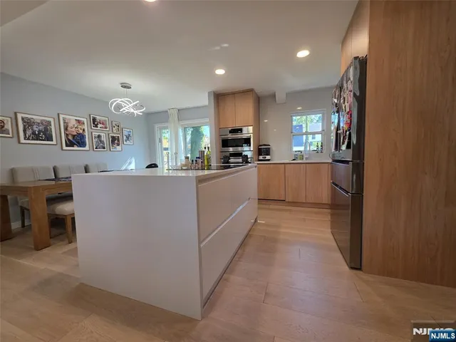 a kitchen with kitchen island cabinets and refrigerator