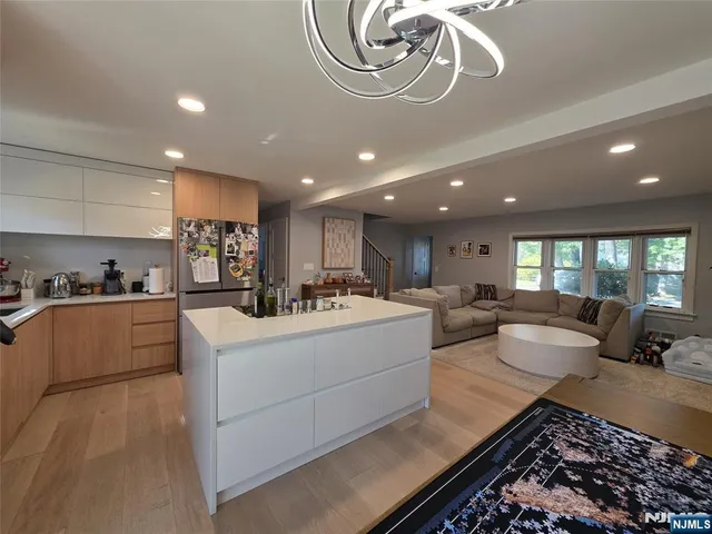 a large white kitchen with a large window