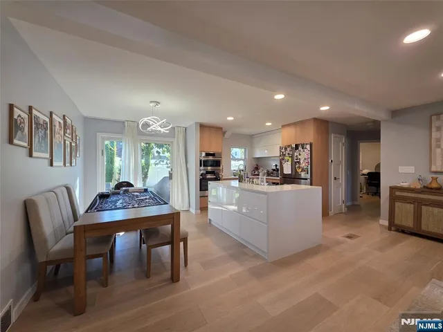 a living room with furniture and kitchen view