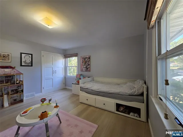 a bed room with furniture and a window