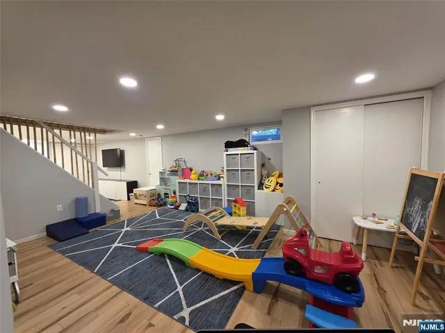 a living room with furniture a wooden floor and gym equipment