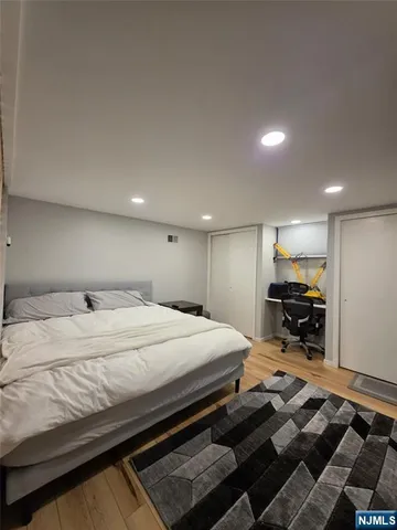 a bed room with furniture and kitchen view