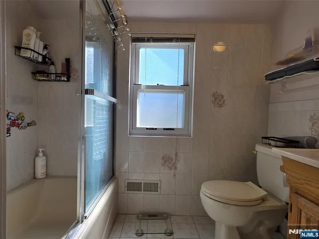 a bathroom with a toilet sink and shower