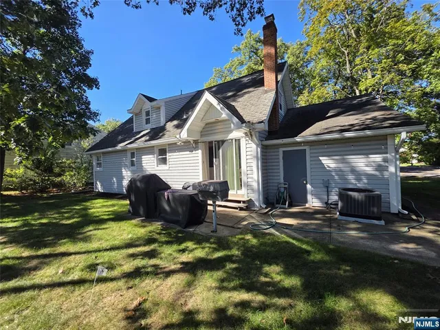 a front view of a house with a garden and patio