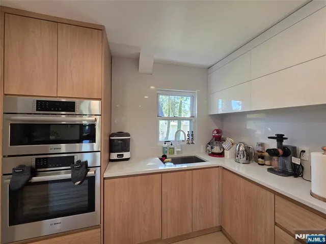 a kitchen with a sink and a stove top oven