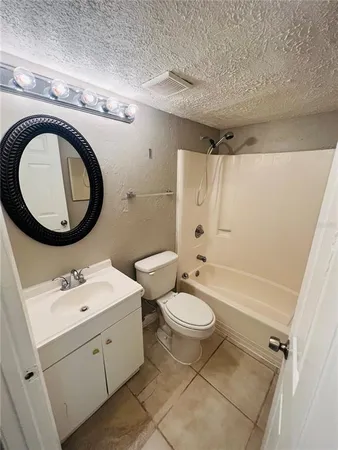 a bathroom with a double vanity sink mirror bathtub and toilet