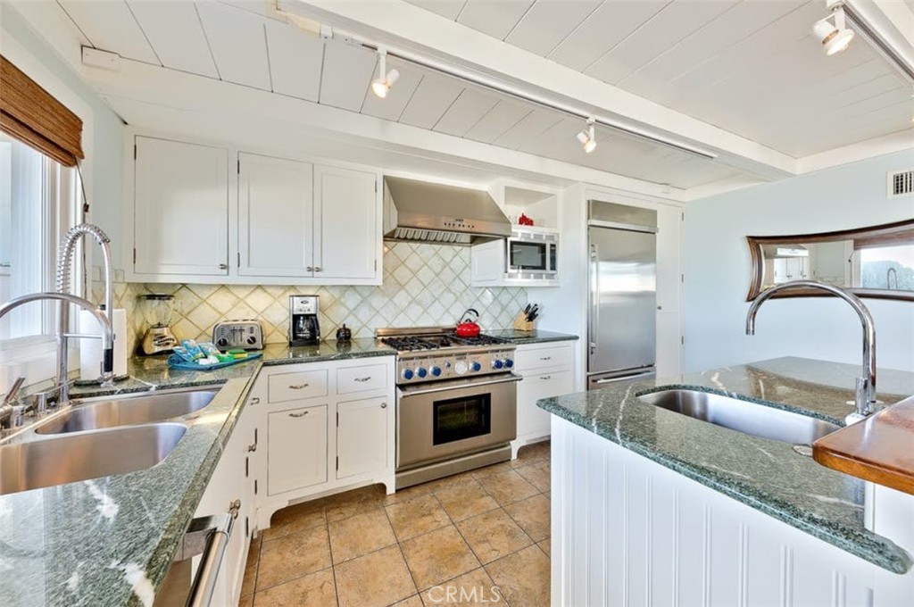 35087 Beach Road Dana Point, CA 92624 - Photo 17 of 31 a kitchen with granite countertop a sink stainless steel appliances and cabinets