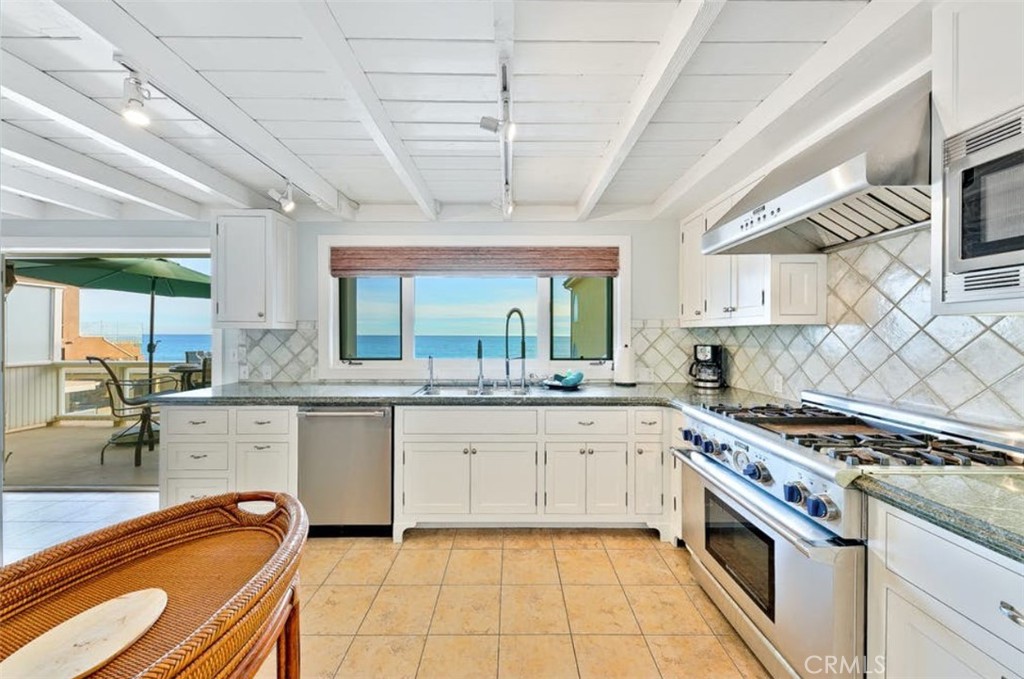 35087 Beach Road Dana Point, CA 92624 - Photo 18 of 31 a large kitchen with stainless steel appliances granite countertop a sink and cabinets