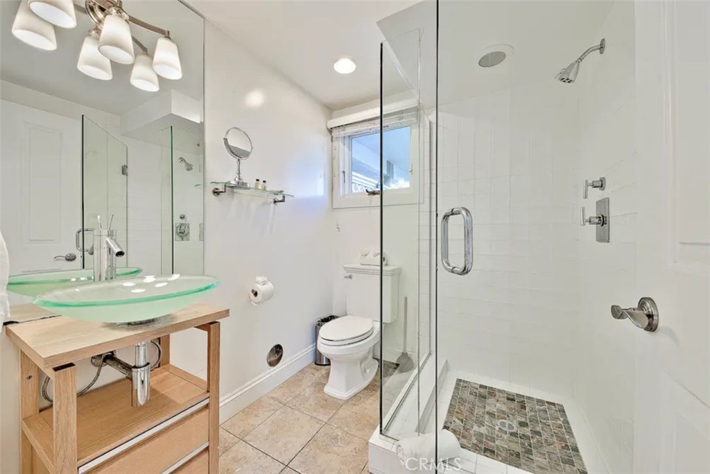 35087 Beach Road Dana Point, CA 92624 - Photo 19 of 31 a bathroom with a sink a toilet a mirror and shower