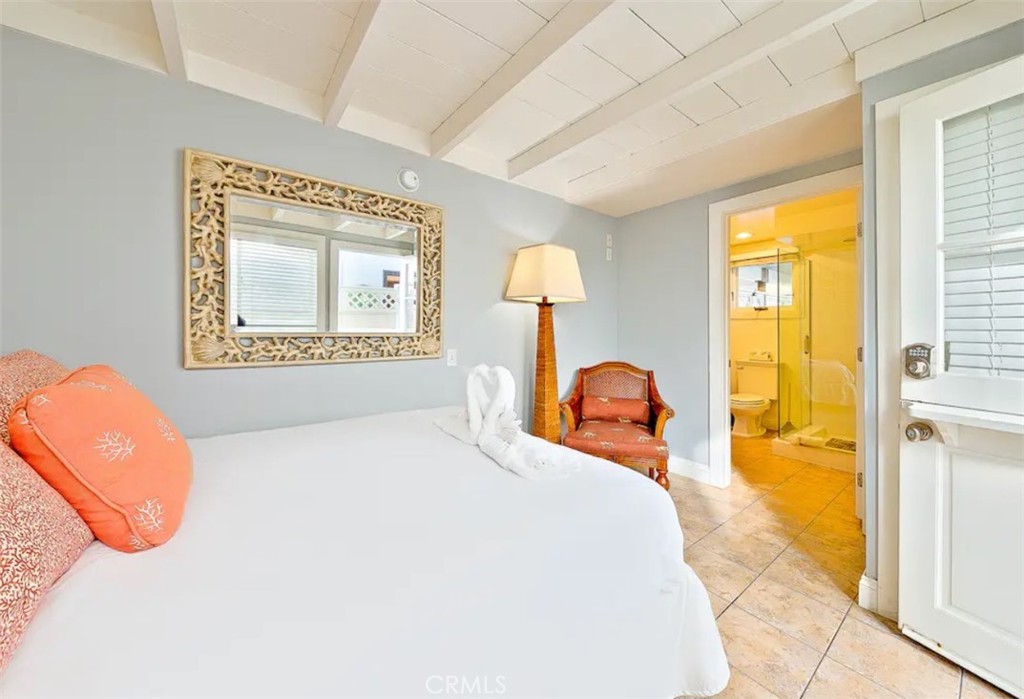 35087 Beach Road Dana Point, CA 92624 - Photo 20 of 31 a bedroom with a bed and a painting on the wall