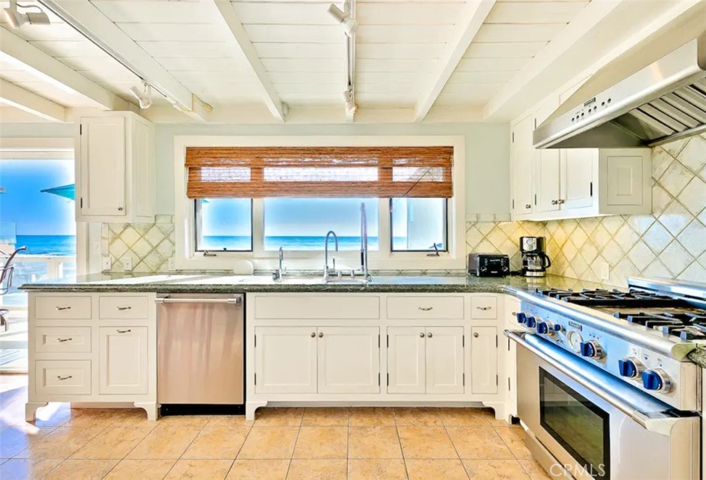 35087 Beach Road Dana Point, CA 92624 - Photo 23 of 31 a kitchen with granite countertop a stove sink and cabinets