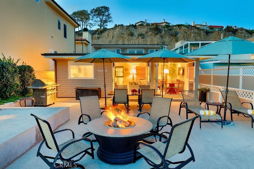 35087 Beach Road Dana Point, CA 92624 - Photo 26 of 31 a view of a patio with table and chairs potted plants with wooden floor and fence