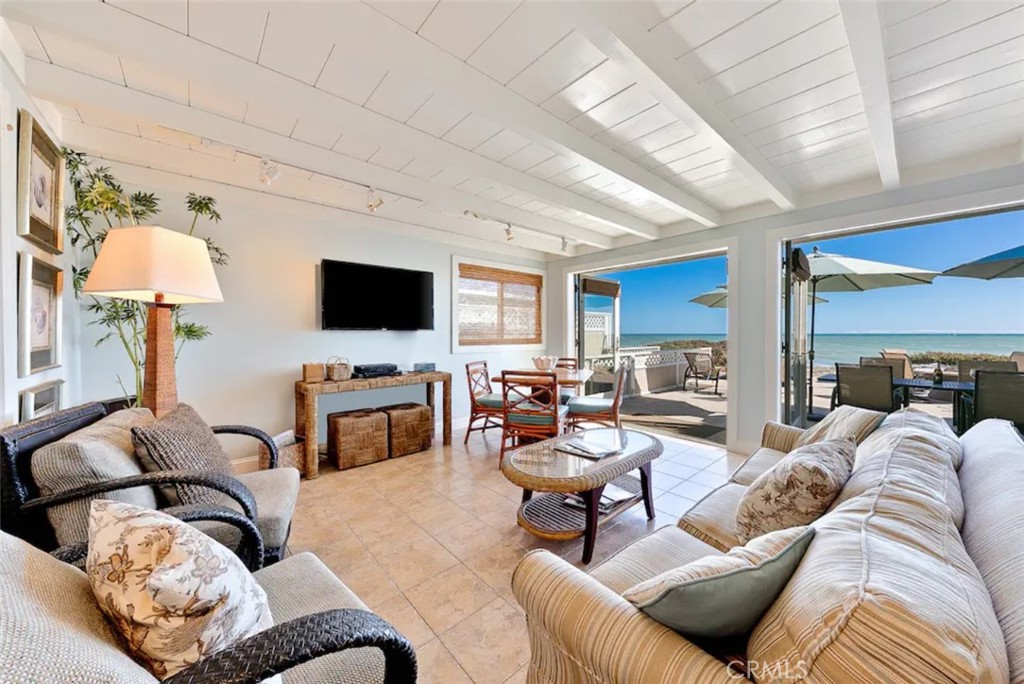 35087 Beach Road Dana Point, CA 92624 - Photo 7 of 31 a living room with furniture a flat screen tv and a fireplace