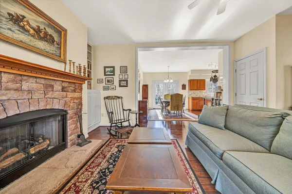 a kitchen with stainless steel appliances granite countertop a stove a sink dishwasher and a refrigerator with wooden floor