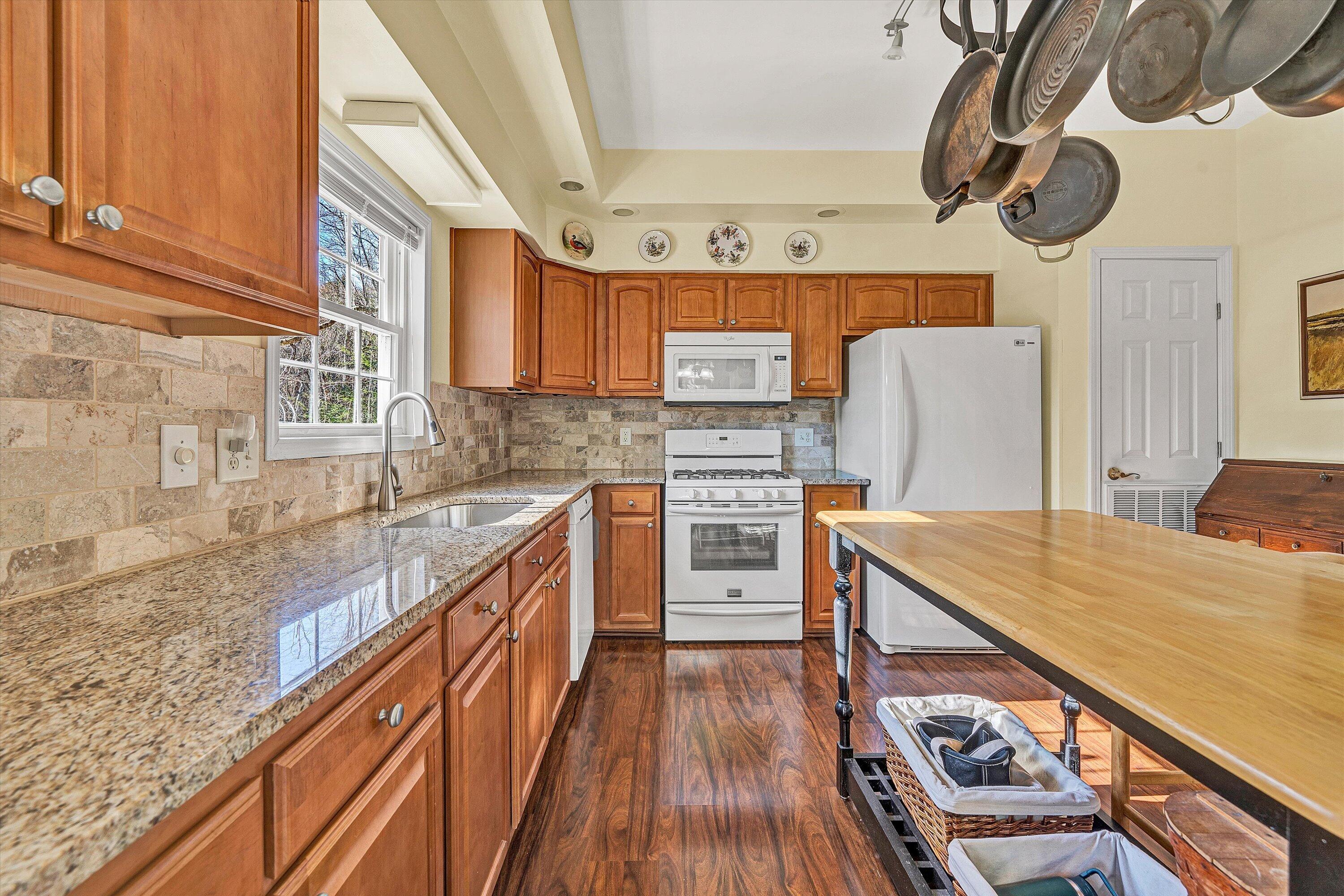 1164 Dry Hill Road Ferrum, VA 24088 - Photo 23 of 84 a kitchen with stainless steel appliances granite countertop a stove a sink dishwasher and a refrigerator with wooden floor