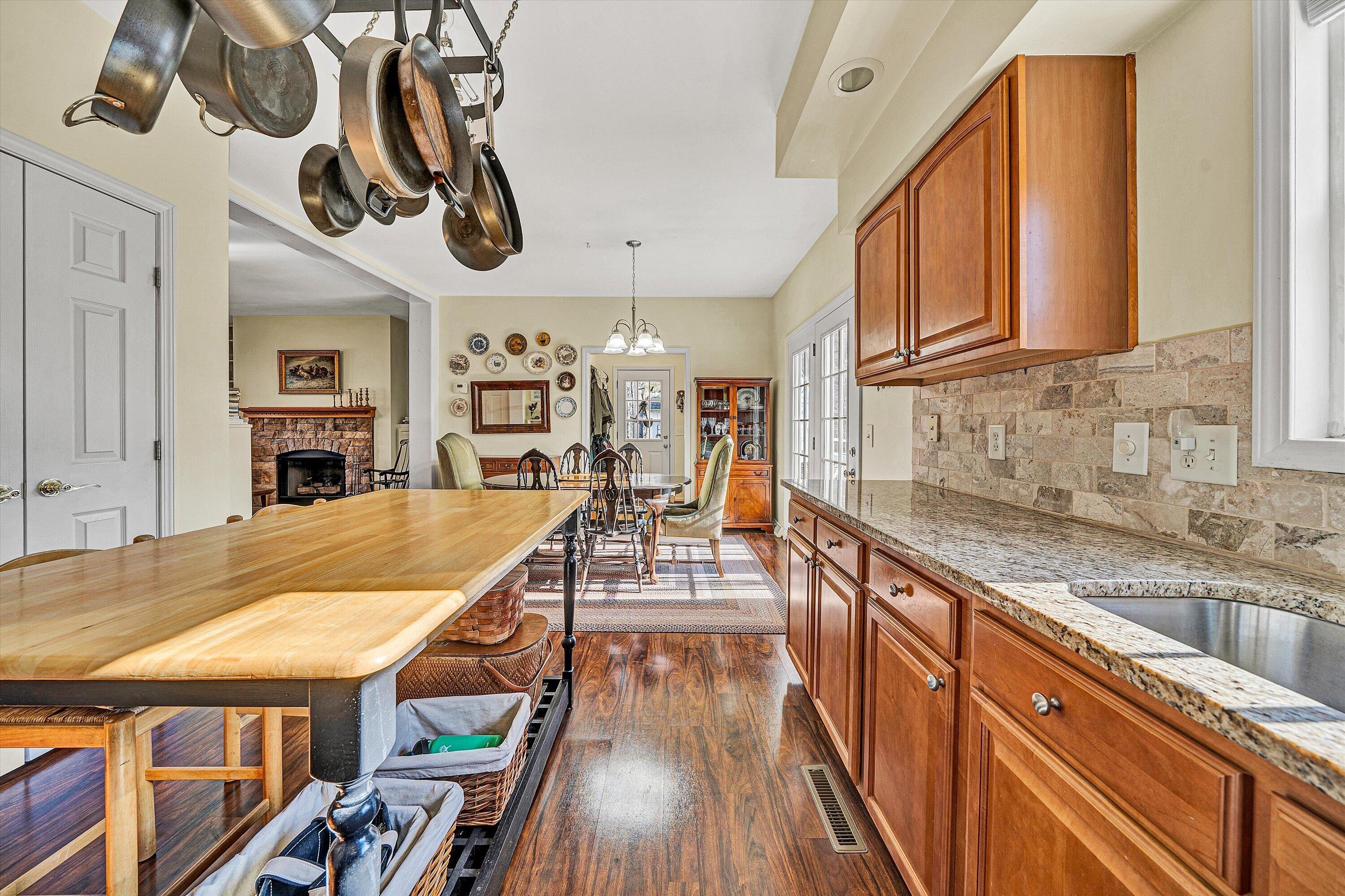 1164 Dry Hill Road Ferrum, VA 24088 - Photo 26 of 84 a kitchen with stainless steel appliances granite countertop a sink and wooden cabinets