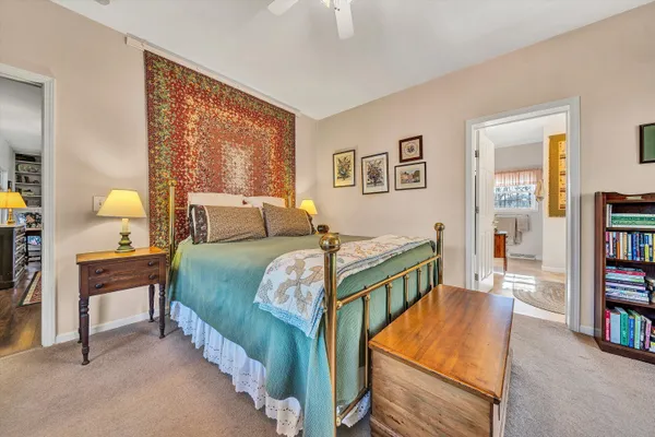 a bedroom with bed and a book shelf