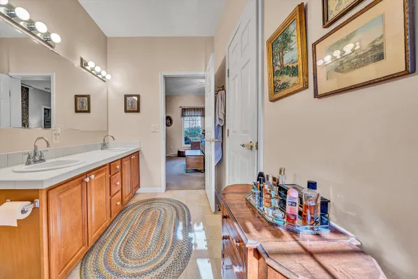 a living room with furniture a flat screen tv and kitchen view