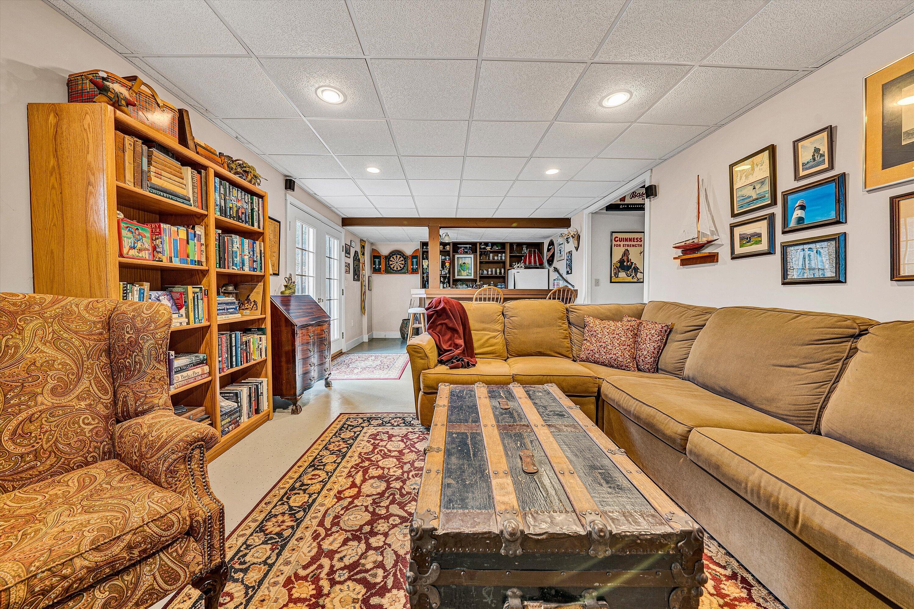 1164 Dry Hill Road Ferrum, VA 24088 - Photo 55 of 84 a living room with furniture a rug and a book shelf