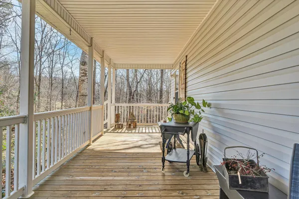 a view of a hallway with wooden floor and entryway