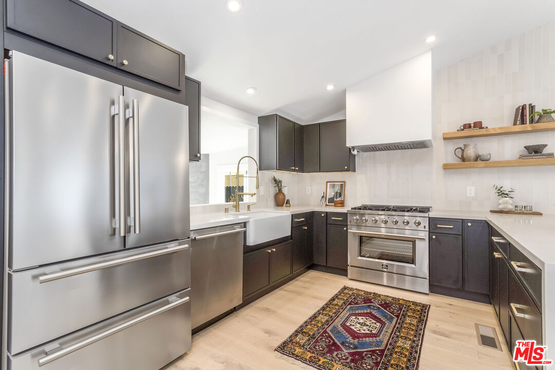 950 North Summit Avenue Pasadena, CA 91103 - Photo 16 of 37 a kitchen with granite countertop stainless steel appliances a sink and counter space