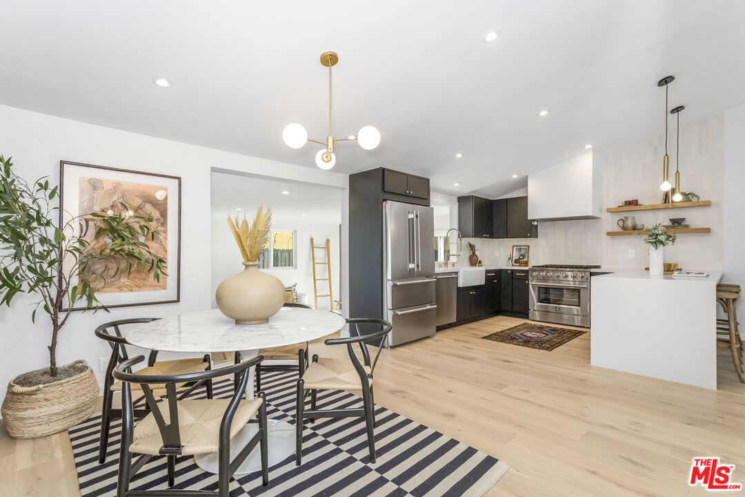 950 North Summit Avenue Pasadena, CA 91103 - Photo 20 of 37 a kitchen with stainless steel appliances a dining table chairs stove and refrigerator