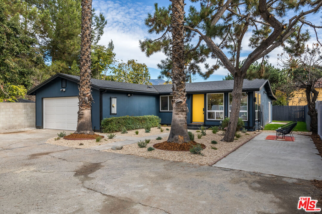950 North Summit Avenue Pasadena, CA 91103 - Photo 4 of 37 a front view of a house with large tree and wooden fence