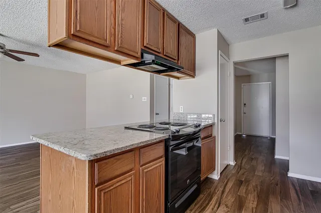 a kitchen with stainless steel appliances granite countertop a sink stove and cabinets