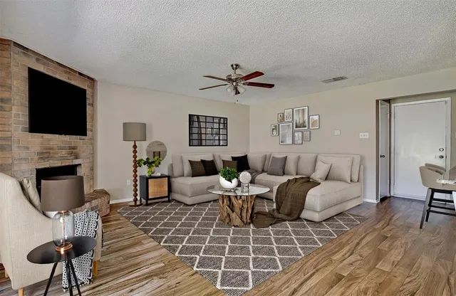 a living room with furniture a fireplace and a flat screen tv