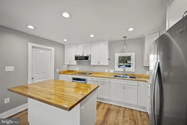 a spacious bathroom with a granite countertop sink and a bathtub