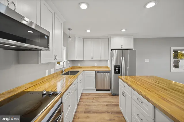 a kitchen with granite countertop a sink and cabinets